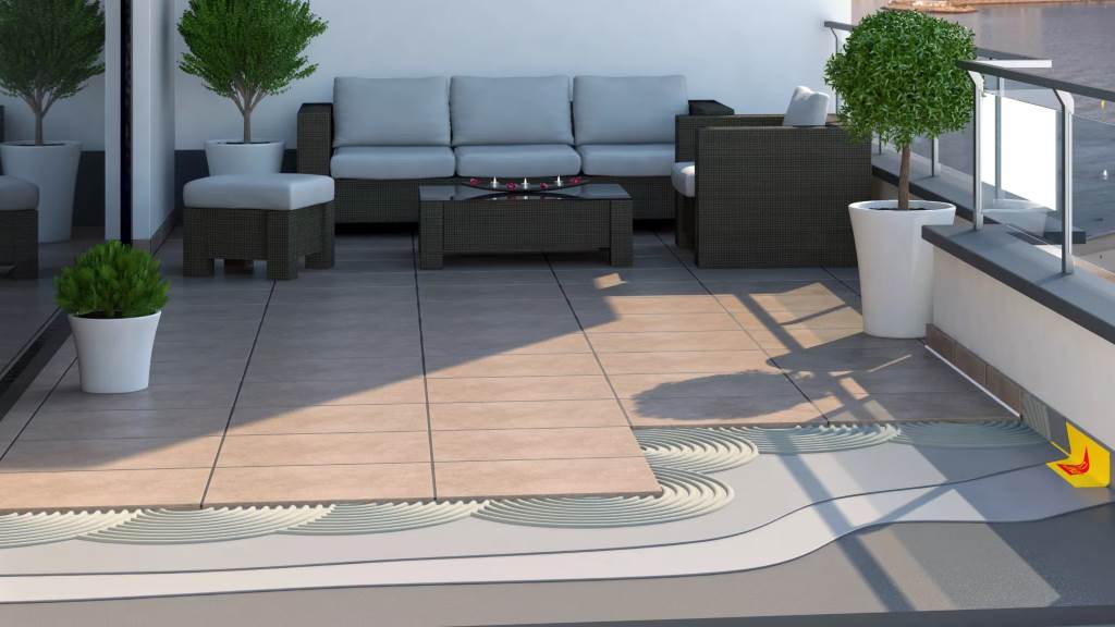 Workers install waterproof peel-and-stick tiles on a sloped balcony surface