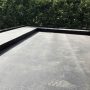 A concrete balcony coated with a shiny liquid waterproofing membrane to prevent leaks