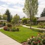 A peaceful care home garden with residents sitting on benches surrounded by flowers and greenery, showing how outdoor spaces can support wellbeing and sustainable living.