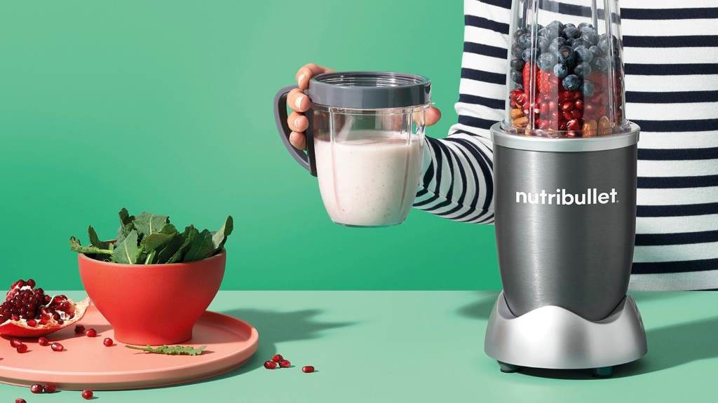 NutriBullet Combo blending berry shake with to-go cup ready for on-the-go use