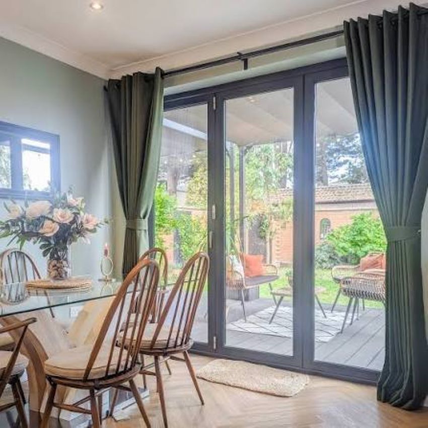 Elegant floor-length curtains enhancing big windows in a bright home interior