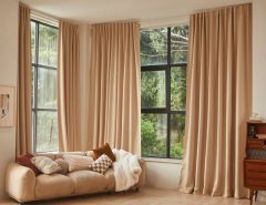Large windows styled with budget-friendly curtains in a modern living room