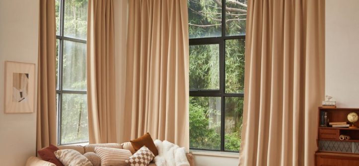 Large windows styled with budget-friendly curtains in a modern living room