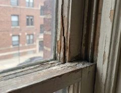 Cracked wooden window sash before repair in Chicago