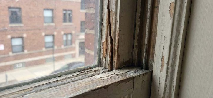Cracked wooden window sash before repair in Chicago